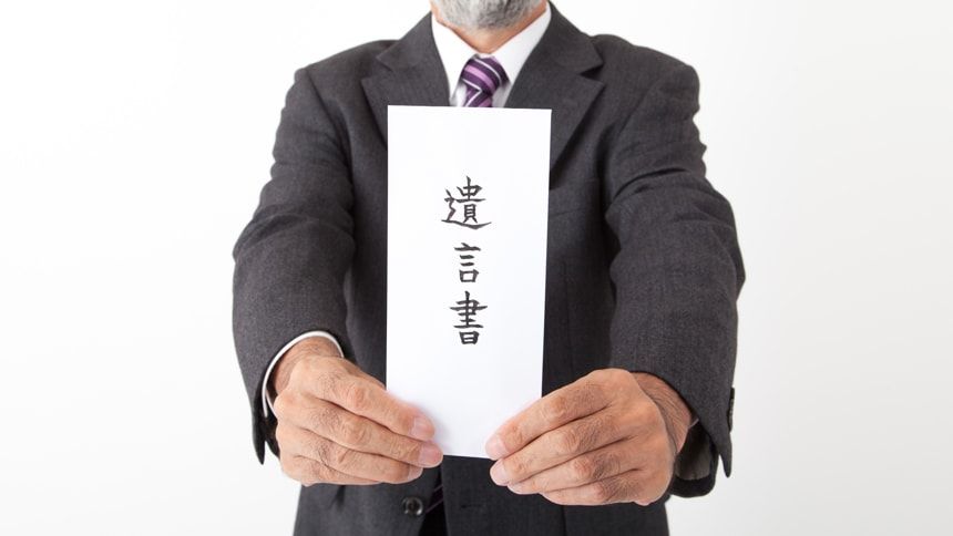 遺言書を持つ男性